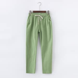 Ljusgröna byxor i bomull och linne som hänger på en galge