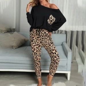 Pyjamas med leopardmönster för kvinnor med en bakgrund i ett stycke